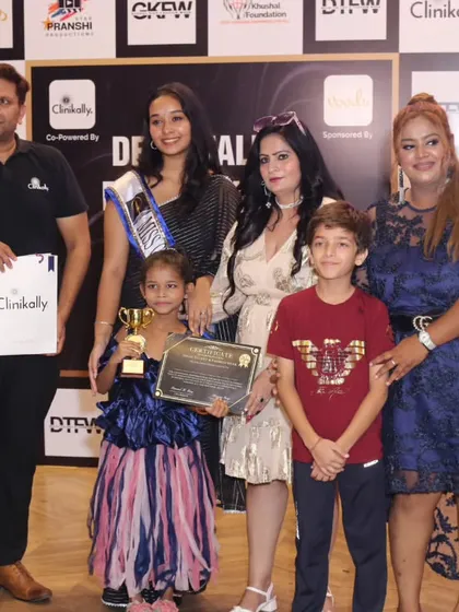 Two of our young winners proudly posing with their awards and the jury panel.