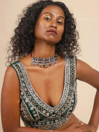 A powerful portrait of the model in the green Shisha blouse, looking directly at the camera. This shot combines product detail with a strong, engaging expression.