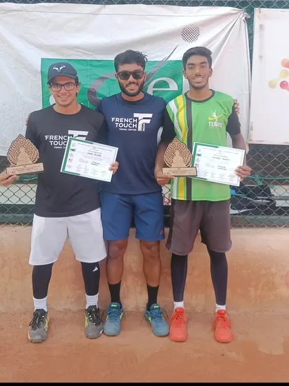 Our players also excel in the men's circuit. A coach stands with our doubles team after their victory in the Men's 1 lac prize money tournament.