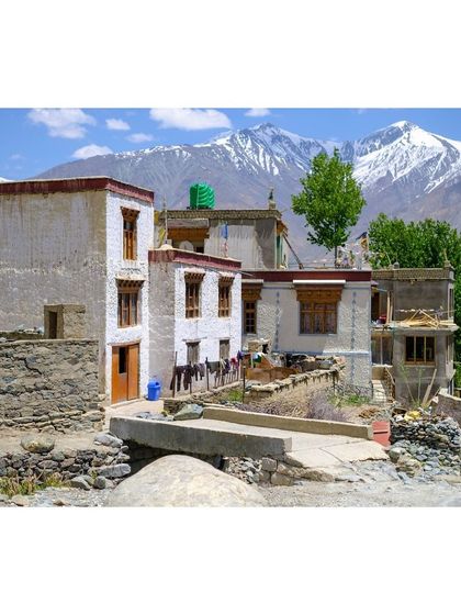 A typical Ladakhi house in the Zanskar Valley, with the majestic snow-capped mountains in the background.