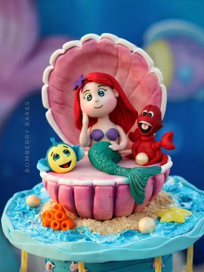Look at the detail on this Little Mermaid cake topper, featuring Ariel, Flounder, and Sebastian. In my figurine classes, we focus on capturing the personality of each character, from facial expressions to posture, all using edible fondant.