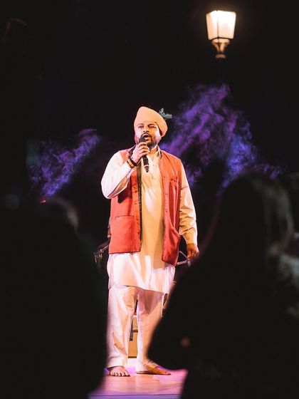 A singer on stage, surrounded by purple smoke and framed by the audience's silhouettes. This photo demonstrates how I use foreground elements to create depth and a sense of being there.