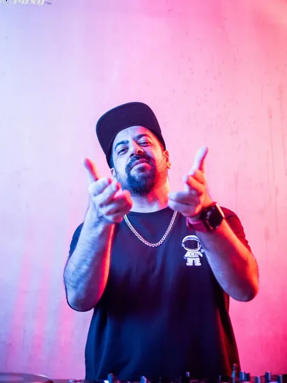 Pointing at the camera, inviting you to join the party.