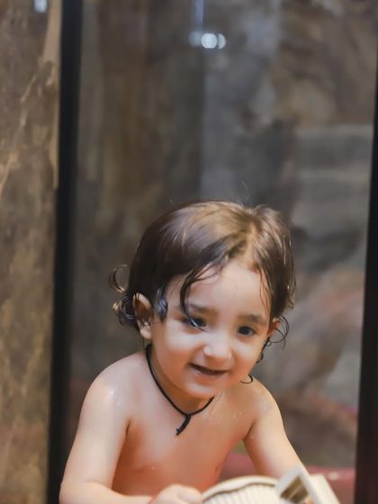 A sweet, smiling baby enjoying the water. These sessions are perfect for capturing your little one's playful side.