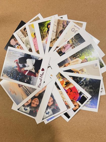 A creative display of many polaroid prints arranged in a circle.