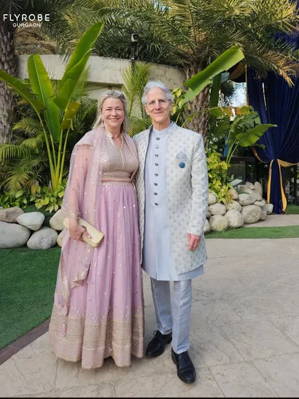 This happy couple is all smiles, dressed in beautiful pastel ethnic wear for a day function. Renting makes it easy to dress for any occasion.