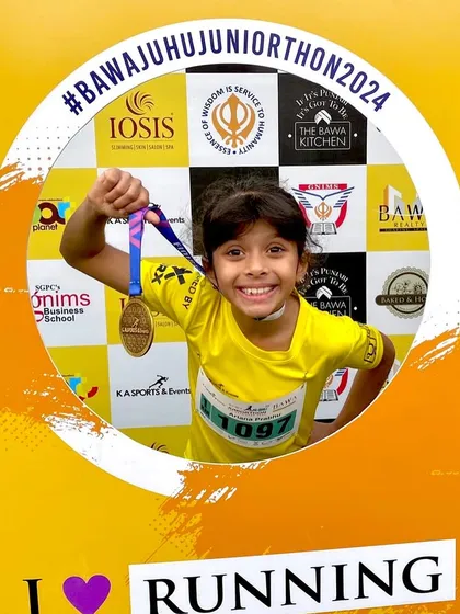 Our youngest athlete celebrating her medal at the Bawa Juhu Juniorthon. It's all about having fun and loving the run.