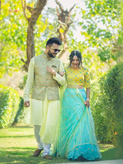 A cheerful walk through a sunlit park. The couple, dressed in bright, coordinated outfits, shares a happy moment, perfectly capturing the spirit of a fun day out.