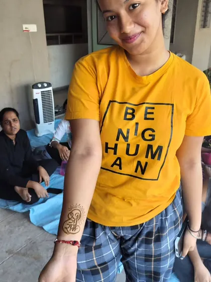 A happy client showing her 'Shree Ram' tattoo. It's amazing how a small design can hold so much meaning.