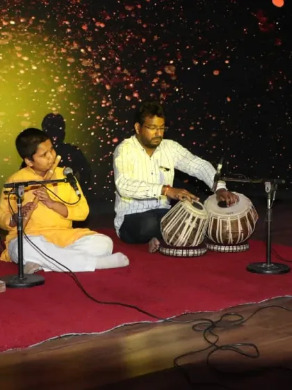 A beautiful moment of 'jugalbandi' between a young flutist and his guru on the tabla. This image embodies our commitment to the Guru-Shishya tradition, where classical training is passed on with personal attention and care.