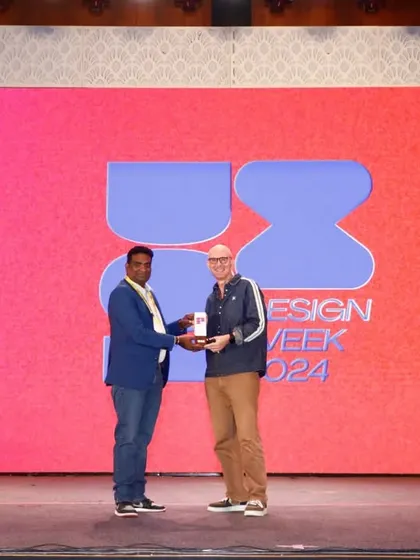 Capturing moments of recognition is a key part of our service. This photo shows an award being presented on stage at the UX Design Week, a critical shot for celebrating achievement and for use in press releases.