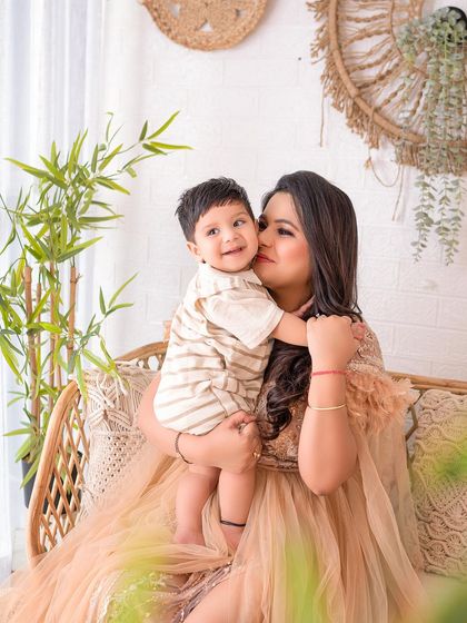 A sweet cuddle and a kiss on the cheek for mom. This photo perfectly captures the affection between a mother and her child.