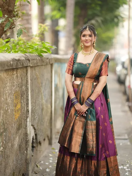 This angle shows the beautiful draping of the saree and the intricate hairstyle.