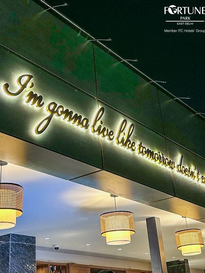 The glowing sign of our rooftop bar stands as a beacon for those seeking a lively night out in East Delhi.