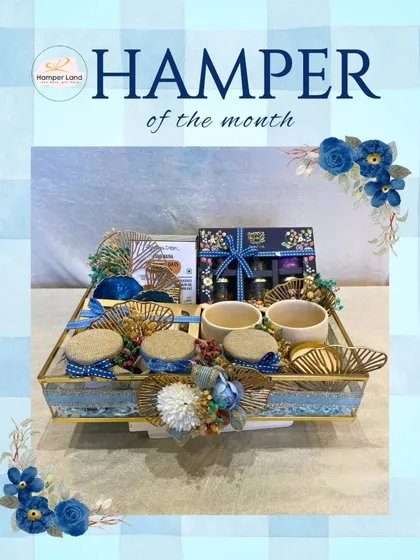 This is my "Hamper of the Month," a beautifully curated gift set in a blue and gold theme. It features a mix of gourmet items and decor, showcasing the kind of ready-to-order, high-quality hampers I offer.