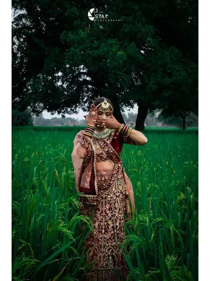 For me, bridal portraits are about capturing quiet, real moments. Here, the bride is in a beautiful green field in Mirzapur, with the rich colours of her lehenga standing out against the natural backdrop.
