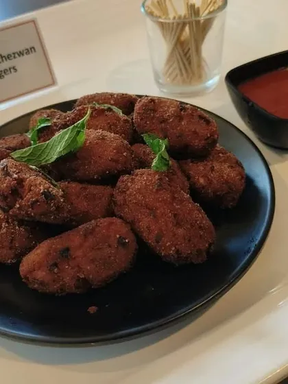 For those who love spicy and savory, we offer Paneer Schezwan Fingers. These are crispy fried paneer batons tossed in a bold Schezwan sauce, making for an addictive starter.