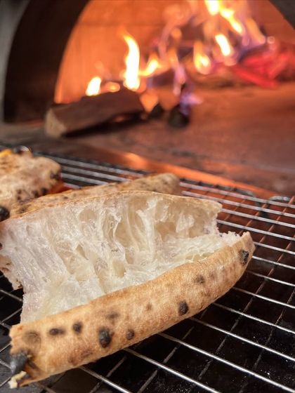 The perfect Neapolitan crust, soft and airy, resting by the fire that gave it life. This is what we mean by fire-kissed.