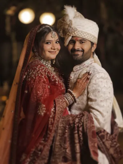 A happy, relaxed portrait of the couple. The bride's makeup looks fresh and effortless, allowing her natural happiness to shine through as the main focus.