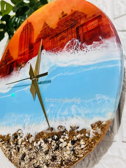 The details matter. Here you can see the fine lines of the temple art and the gentle lapping of the resin waves against the shore on this custom spiritual clock.