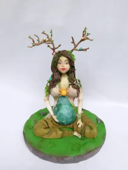 This Mother Earth figurine is a piece of pure sugar art that I'm very proud of. It shows the level of detail and sculpting you can achieve with gumpaste, from the facial features to the delicate branches and leaves.