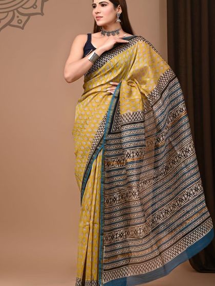 A mustard yellow pure Chanderi cotton silk saree with a traditional printed body and pallu.