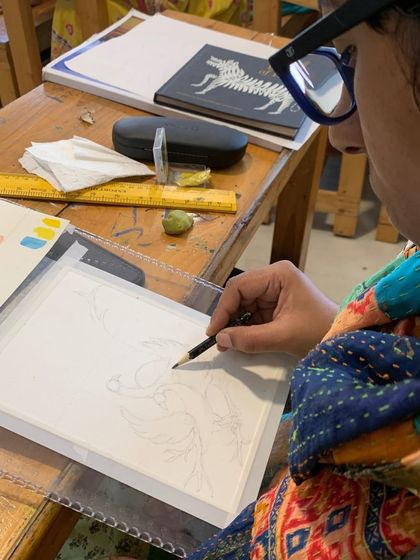 A student begins a new piece, carefully sketching the outline. Our structured courses cater to all skill levels, from hobbyists to certification seekers.