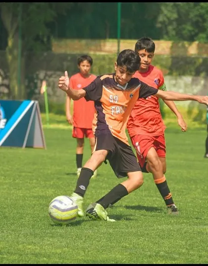A player showing great close control to beat his opponent in a tight space.