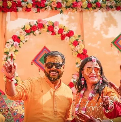 The couple celebrates with their guests, pointing and laughing. Our event photography captures the dynamic energy and participation of everyone involved.