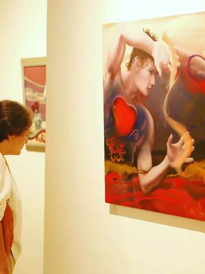 A visitor contemplating a piece from my "Soulmates" series. My goal is for the art to create a moment of personal reflection for the viewer.
