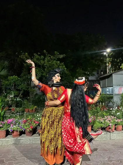 A back pose of Shiva and Parvati, showcasing their beautiful costumes and hair adornments. Even from the back, their divine presence is palpable.
