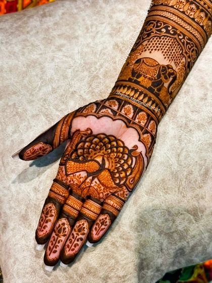 A close-up of the peacock motif on the palm from the previous design.