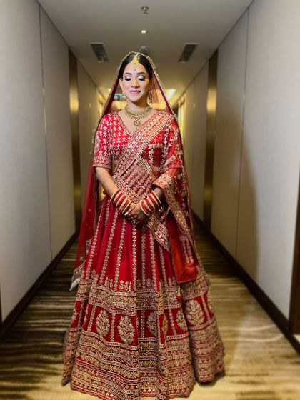 A full length shot where she looks like a true queen. The makeup completes her regal bridal look.