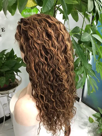 Custom coloring isn't just for straight hair. I created these beautiful golden highlights on a curly human hair wig, defining each curl and adding incredible dimension and texture for a vibrant, natural look.