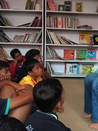 A storyteller captivates a group of boys at the Kings of Castle Library. The children are completely engrossed, their eyes fixed on the book as the story unfolds. These sessions are a cornerstone of our therapeutic approach.