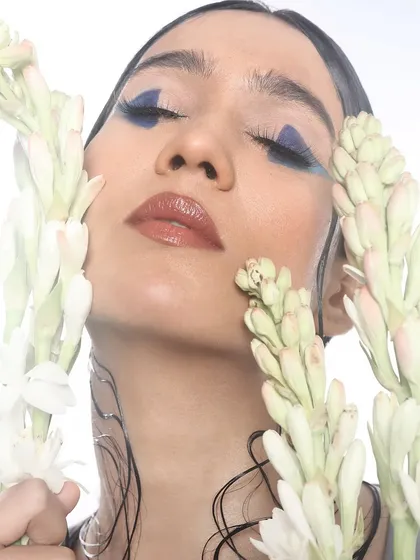A dreamy, expressive shot that highlights the unique shape and bold color of the graphic liner.