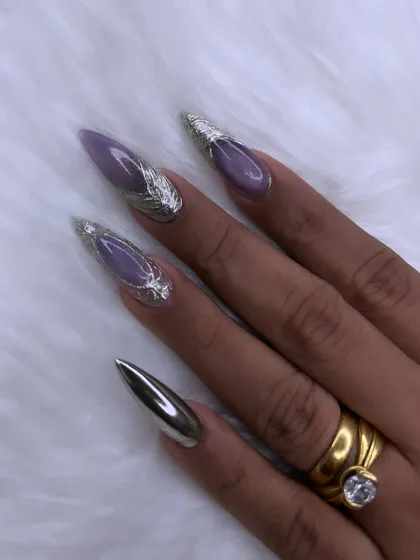 This is where nail art becomes high fashion. I created this dramatic look using sharp stiletto extensions, a soft lavender base, and striking 3D silver chrome accents for a futuristic and elegant finish.