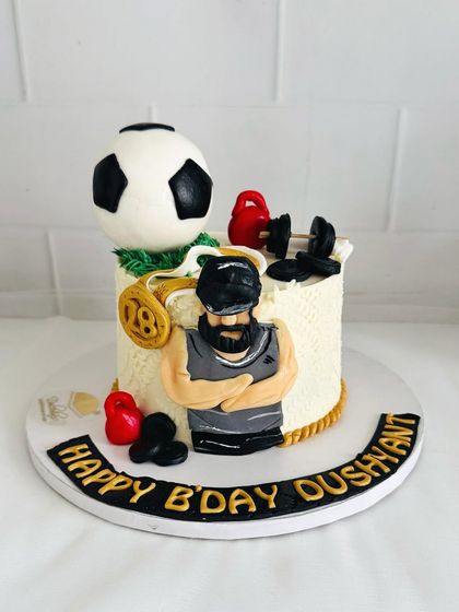 A cake for someone who loves fitness and football, topped with a fondant soccer ball, dumbbells, and a personalized caricature.