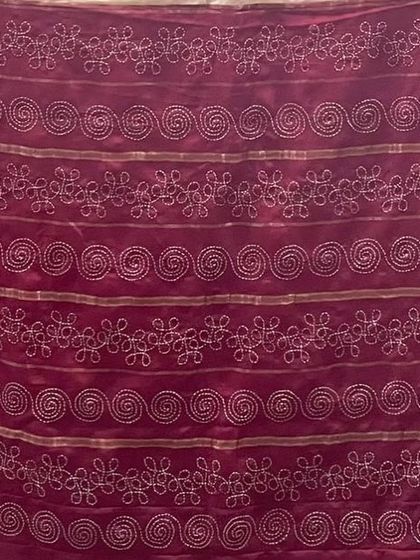 This fabric shows different patterns that can be created with hand embroidery, from spirals to floral chains. It's a sampler of possibilities for custom work.