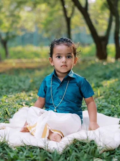 A little boy in traditional Indian ethnic wear, looking serene and handsome during an outdoor shoot for Pongal.