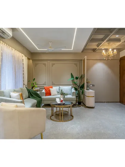 A wide shot capturing the flow from the living area to the TV unit and entryway. The consistent use of soft grey tones and elegant mouldings creates a cohesive and expansive feel throughout the space.