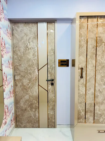 A view of the marble-finish wardrobe and matching bedroom door, creating a cohesive and high-end look.