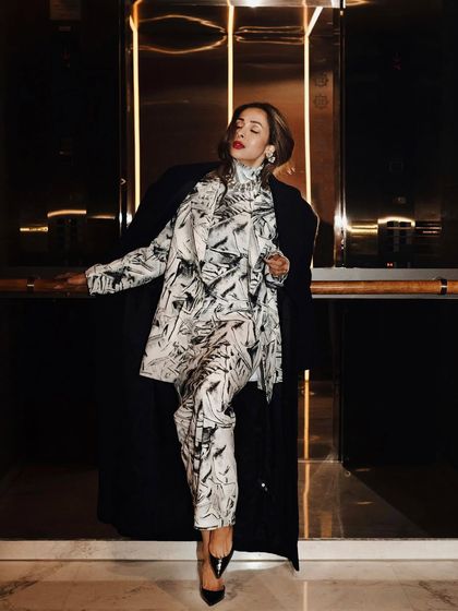 Another shot from the elevator series, with a pose that conveys confidence and glamour.