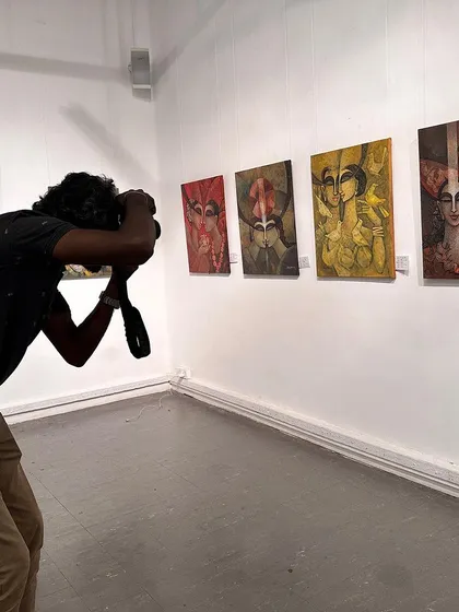 A photographer capturing my paintings on display at the international exhibition in Colombo.