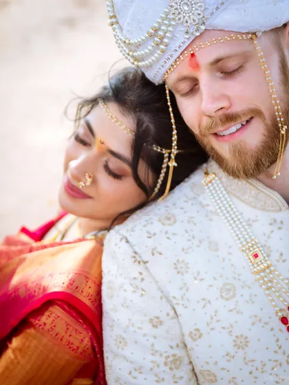 A tender moment between the bride and groom. Her soft makeup and traditional attire look serene and beautiful against his classic sherwani.