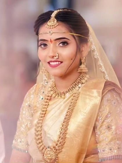 A lovely close up portrait of the bride. You can clearly see the details on the choker, the layered necklace, and the delicate maangtika and nose ring, all part of the complete bridal rental set.