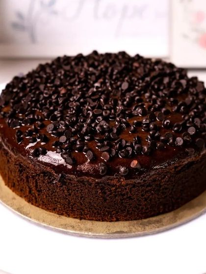 A classic chocolate truffle cake covered in chocolate chips, a simple yet irresistible treat.