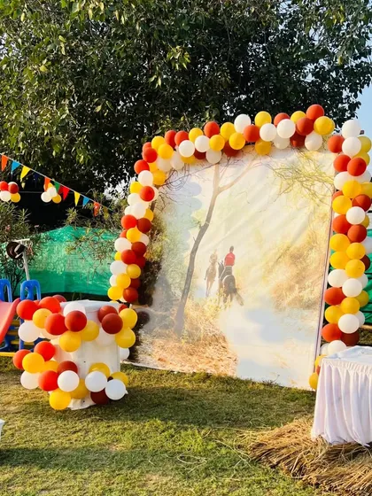 A beautiful balloon arch frames a photo backdrop, perfect for capturing memories of the special day.
