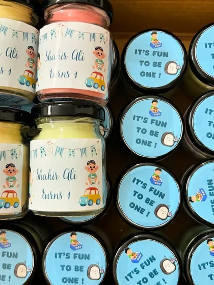 How cute are these return gifts for a first birthday party? We designed the labels to match the party's theme and even added the birthday boy's name.