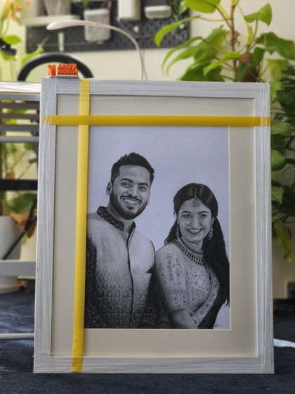 This framed couple portrait, captured in my studio, shows how the final piece looks ready for display. It took over 35 hours to complete this detailed charcoal and graphite drawing.